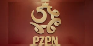 Piłkarz stojący na boisku z cieniem zakładów bukmacherskich i symbolem skandalu match-fixingu w polskiej piłce.